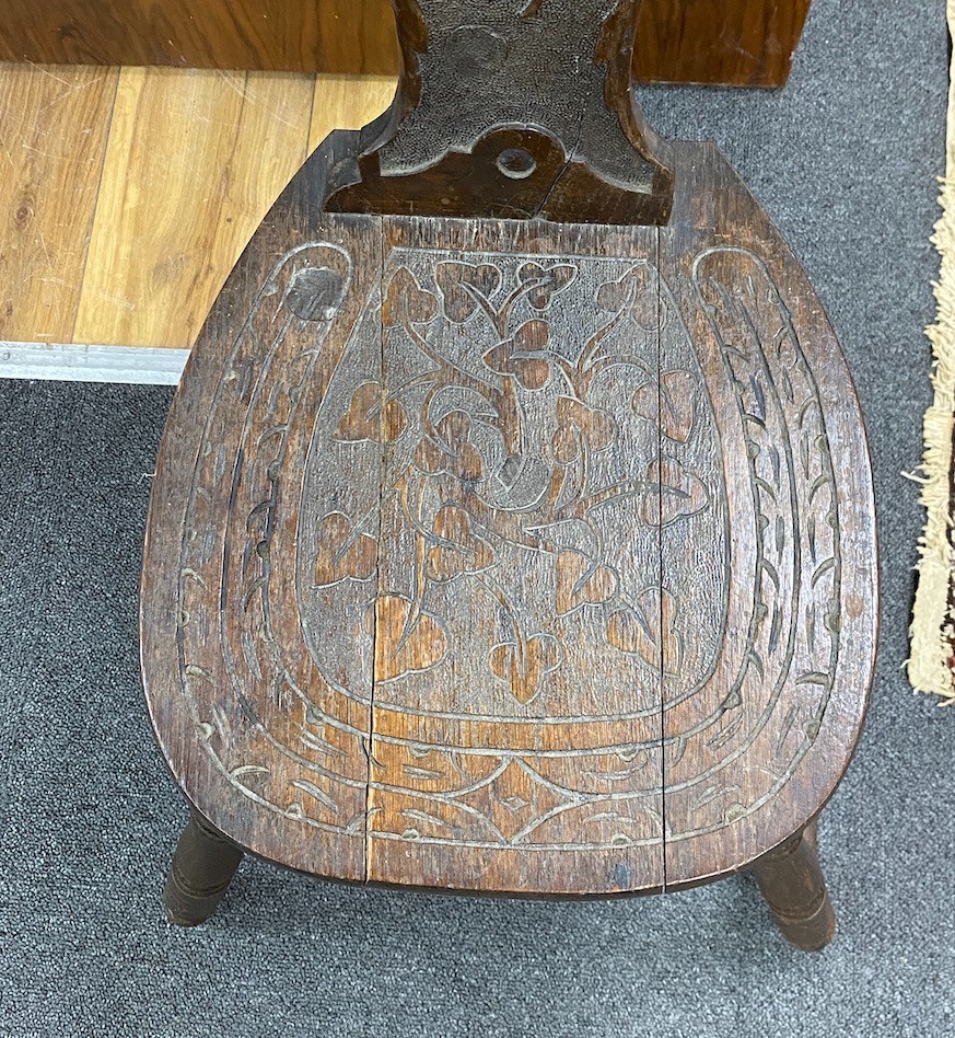 A Victorian carved oak spinning chair, by repute made from the timbers of HMS Foudroyant, dated 1897, height 88cm